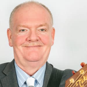 Headshot of Rex with guitar